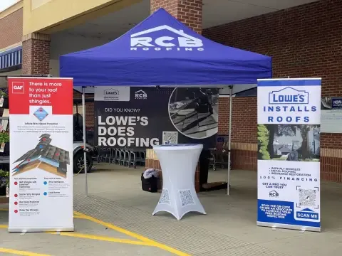 RCB Roofing booth with Lowe's Installs Roofs banner